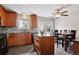 Updated kitchen with wooden cabinets, stainless steel appliances, tile backsplash, and an island at 12235 Garfield Pl, Thornton, CO 80241