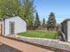 Lovely backyard featuring a well-manicured lawn, decorative stone accents, and a charming shed at 4747 S Elati St, Englewood, CO 80110