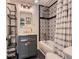 Updated bathroom with patterned tile shower, vanity with shelving, and modern fixtures at 4747 S Elati St, Englewood, CO 80110