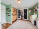 Bedroom with hardwood floors, wood closet doors, shelves, and a view into the hallway at 4747 S Elati St, Englewood, CO 80110