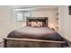 A bedroom featuring a large bed, white walls, and built-in shelving at 4747 S Elati St, Englewood, CO 80110