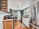 Well-lit kitchen featuring modern appliances, ample countertop space, and stylish cabinetry at 4747 S Elati St, Englewood, CO 80110