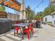 Inviting patio area with a pergola, dining table, grill, and comfortable seating, perfect for outdoor entertaining at 4747 S Elati St, Englewood, CO 80110