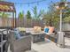Back patio area with lounge seating, gas fire pit, pergola, and heating lamps at 4747 S Elati St, Englewood, CO 80110