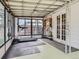 Sunroom featuring a treadmill, string lights, and large windows overlooking the backyard at 4747 S Elati St, Englewood, CO 80110