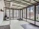 Open sunroom with large windows offering a view of the private, landscaped yard at 4747 S Elati St, Englewood, CO 80110