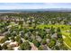 Picturesque aerial view of the community with golf course, ponds and mountain views in the distance at 2678 S Xanadu Way # C, Aurora, CO 80014