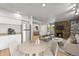 Open-concept living area with stone fireplace, modern kitchen, and stylish furniture at 2678 S Xanadu Way # C, Aurora, CO 80014