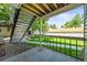 Covered outdoor patio provides a relaxing space with steps to the backyard, surrounded by lush landscaping at 2678 S Xanadu Way # C, Aurora, CO 80014