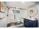 Modern bathroom with glass shower, statement mirror, and stylish blue vanity at 5925 E Fair Ave, Centennial, CO 80111