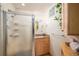 Bright bathroom featuring a glass-enclosed shower and a single sink vanity at 5925 E Fair Ave, Centennial, CO 80111