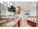 Beautiful bathroom boasts double sinks, granite countertops, and a large mirror with a built-in television at 5925 E Fair Ave, Centennial, CO 80111