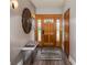 Elegant foyer featuring a wood door with glass panels, bench, and stylish decor at 5925 E Fair Ave, Centennial, CO 80111