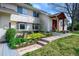 Charming home with colorful landscaping, a brick walkway, and a covered front porch at 5925 E Fair Ave, Centennial, CO 80111