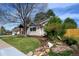 A beautifully landscaped front yard complements this attractive home's inviting curb appeal at 5925 E Fair Ave, Centennial, CO 80111