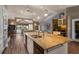 Spacious kitchen island, bar with sink and view to living area in an open floorplan home at 5925 E Fair Ave, Centennial, CO 80111