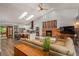 Open-concept living area with skylights, fireplace, and seamless transition to the kitchen at 5925 E Fair Ave, Centennial, CO 80111
