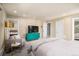 Relaxing main bedroom boasts plush carpeting, calming colors, and a comfortable sitting area at 5925 E Fair Ave, Centennial, CO 80111