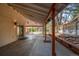 Covered patio features concrete flooring, wooden support beams, and backyard access at 5925 E Fair Ave, Centennial, CO 80111