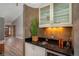 Elegant wet bar features granite counters, cabinet storage, under-cabinet lighting, and beverage refrigerator at 5925 E Fair Ave, Centennial, CO 80111