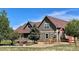 Spacious backyard showcasing a well-maintained lawn, mature trees, and a back porch at 690 Antelope Dr, Bennett, CO 80102