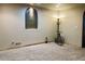 Neutral carpeted basement showcasing a custom niche and unique tricycle decor at 690 Antelope Dr, Bennett, CO 80102