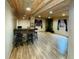 Finished basement with a stone bar, wood ceiling, wood-look flooring, and fireplace at 690 Antelope Dr, Bennett, CO 80102