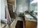 Bathroom featuring a glass enclosed shower, granite vanity, and plenty of natural light at 690 Antelope Dr, Bennett, CO 80102