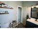 This half bathroom features a vanity, toilet, and decorative shelves, combining functionality and style at 690 Antelope Dr, Bennett, CO 80102