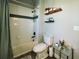 This full bathroom has a shower, toilet, and decorative shelves, offering a serene and practical space at 690 Antelope Dr, Bennett, CO 80102