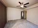 This bedroom features carpeted floors and a ceiling fan, offering a cozy and inviting atmosphere at 690 Antelope Dr, Bennett, CO 80102