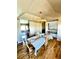 Elegant dining room with hardwood floors, a stylish chandelier, and views into the kitchen at 690 Antelope Dr, Bennett, CO 80102