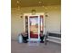 Inviting front entrance with a charming bench, potted flowers, and string lights overhead at 690 Antelope Dr, Bennett, CO 80102