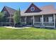 Charming home with a large front porch, red shutters, and well-manicured lawn at 690 Antelope Dr, Bennett, CO 80102