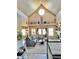 Bright and airy living room with tall ceilings, large windows, and a cozy fireplace at 690 Antelope Dr, Bennett, CO 80102