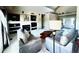 Spacious living room features plush seating and access to dining and kitchen areas at 690 Antelope Dr, Bennett, CO 80102