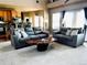 Open living room boasts lots of natural light, neutral carpet, and comfortable seating at 690 Antelope Dr, Bennett, CO 80102