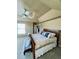 Spacious primary bedroom with a ceiling fan, natural light, and en suite bathroom at 690 Antelope Dr, Bennett, CO 80102