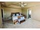 Vaulted main bedroom with ceiling fan, lots of light and views to en suite bathroom at 690 Antelope Dr, Bennett, CO 80102