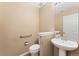 Half bath features a pedestal sink, a framed mirror, and neutral walls at 6418 Silver Mesa Dr # C, Highlands Ranch, CO 80130