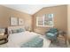 Bedroom with a view features a large window, a blue upholstered chair, and soft decor at 6418 Silver Mesa Dr # C, Highlands Ranch, CO 80130