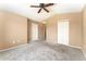Spacious carpeted bedroom with vaulted ceilings, a ceiling fan, and a double-door closet at 6418 Silver Mesa Dr # C, Highlands Ranch, CO 80130