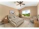 Comfortable bedroom boasts a vaulted ceiling, large window with a view, and stylish furnishings at 6418 Silver Mesa Dr # C, Highlands Ranch, CO 80130