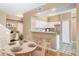 Dining area and kitchen with bar seating, white cabinets, and stainless steel refrigerator at 6418 Silver Mesa Dr # C, Highlands Ranch, CO 80130