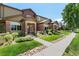 Attractive townhouse exterior featuring lush landscaping and a well-manicured lawn at 6418 Silver Mesa Dr # C, Highlands Ranch, CO 80130