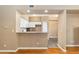 Bright kitchen with breakfast bar overlooking living area, white cabinetry, and tile floor at 6418 Silver Mesa Dr # C, Highlands Ranch, CO 80130