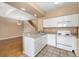 Open kitchen with white appliances, light countertops, and a view of the living area at 6418 Silver Mesa Dr # C, Highlands Ranch, CO 80130