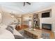 Cozy living room with fireplace, open to the kitchen, and a view of the dining area at 6418 Silver Mesa Dr # C, Highlands Ranch, CO 80130