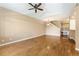 Spacious living room featuring hardwood floors, ceiling fan, and staircase access at 6418 Silver Mesa Dr # C, Highlands Ranch, CO 80130