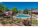 Community swimming pool area, fenced with comfortable loungers and well-manicured landscaping around at 6418 Silver Mesa Dr # C, Highlands Ranch, CO 80130